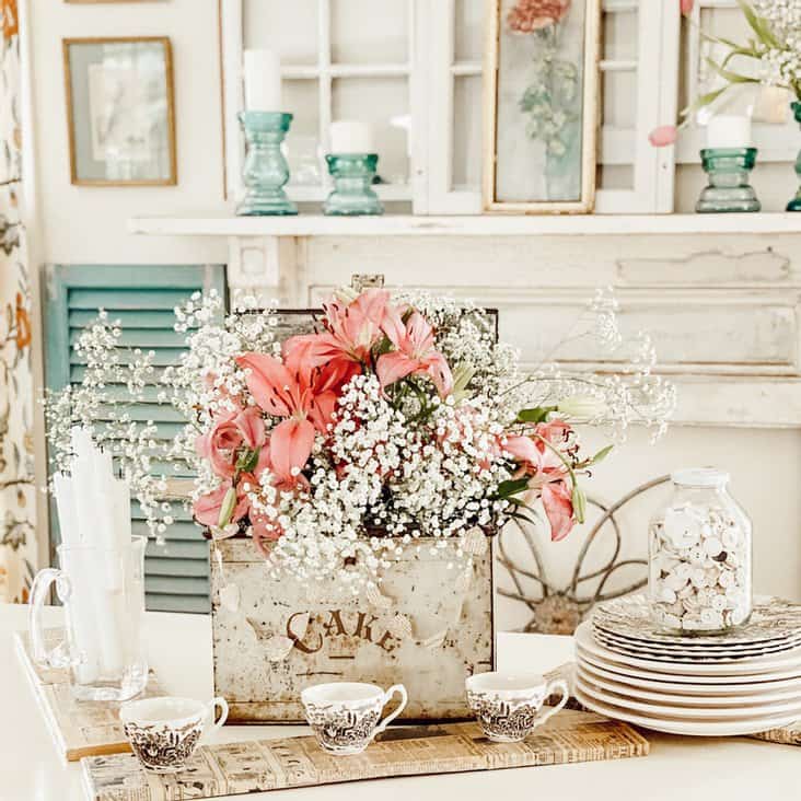 Elegant pink lilies and baby's breath in a vintage-inspired setting for home floral decor, ideal for adding charm to your living space.
