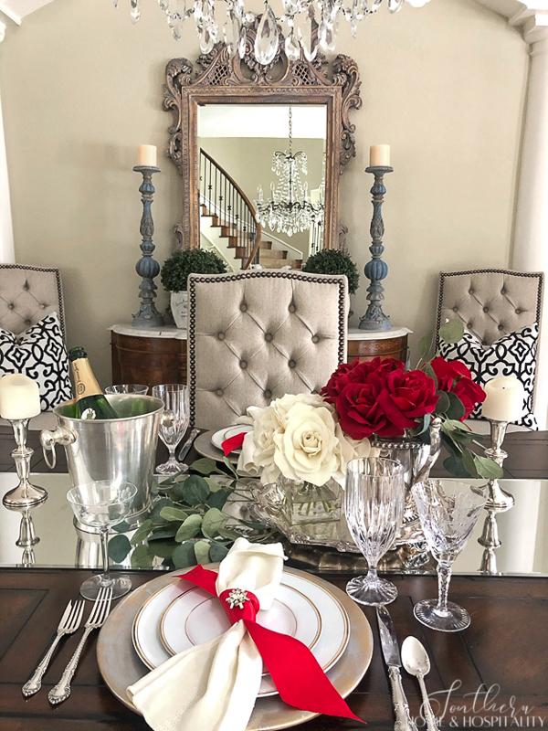 Luxurious place setting with floral centerpiece, crystal glassware, and sophisticated tableware for refined entertaining.