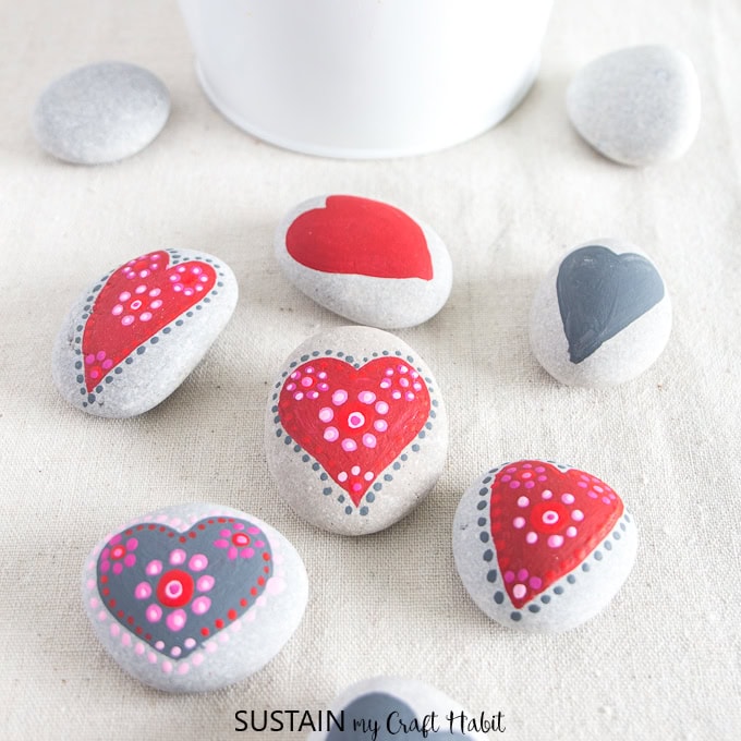 Colorful painted rocks with heart designs for home decor, gifts, or crafts. Perfect for Valentine's Day or adding a personal touch to any space. Hand-painted stones for inspiration and love.