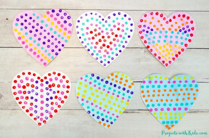 Brightly painted heart-shaped crafts with multicolored polka dots on white backgrounds, perfect for Valentine's Day or gift decorations.