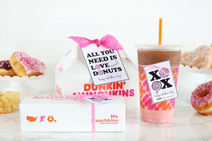 Delicious donuts, iced coffee, and heartfelt Valentine's Day gifts from Dunkin' Donuts on a white marble tabletop.