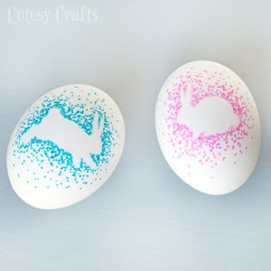Bright pink and blue speckled eggs with artistic patterns for spring decorations, showcasing handcrafted ceramic or painted designs, perfect for Easter or festive occasions.