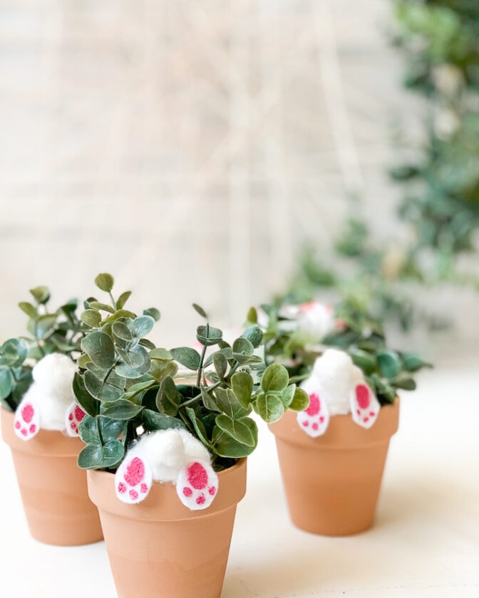 Cute Easter bunny tail felt ornaments on potted greenery, perfect for spring decor, Easter celebration, and festive home accents.