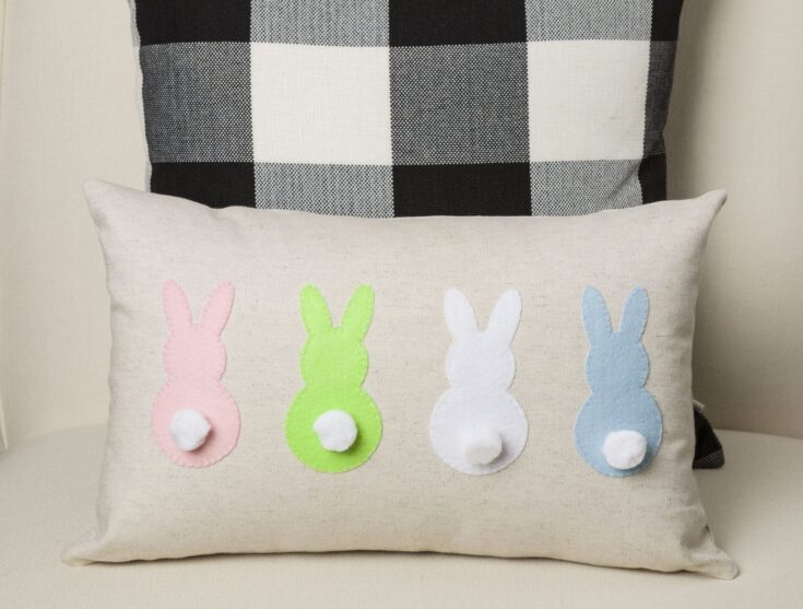Cute pastel felt bunny pillows with white pom-pom tails, perfect for children's bedroom decor or nursery accents. Soft, cozy, and charming Easter-themed home decor.