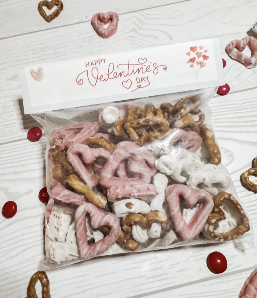 Delicious Valentine’s Day cookie assortment with pink, white, and brown pretzels in a clear bag with Valentine’s themed label. Perfect for Valentine's Day treats.