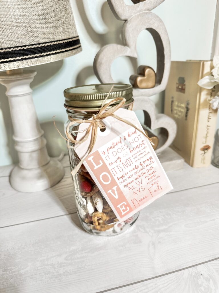 Personalized love jar filled with treats, featuring a heartfelt tag with inspiring quote about patience, kindness, and never giving up on love, perfect for romantic gifts or decor.