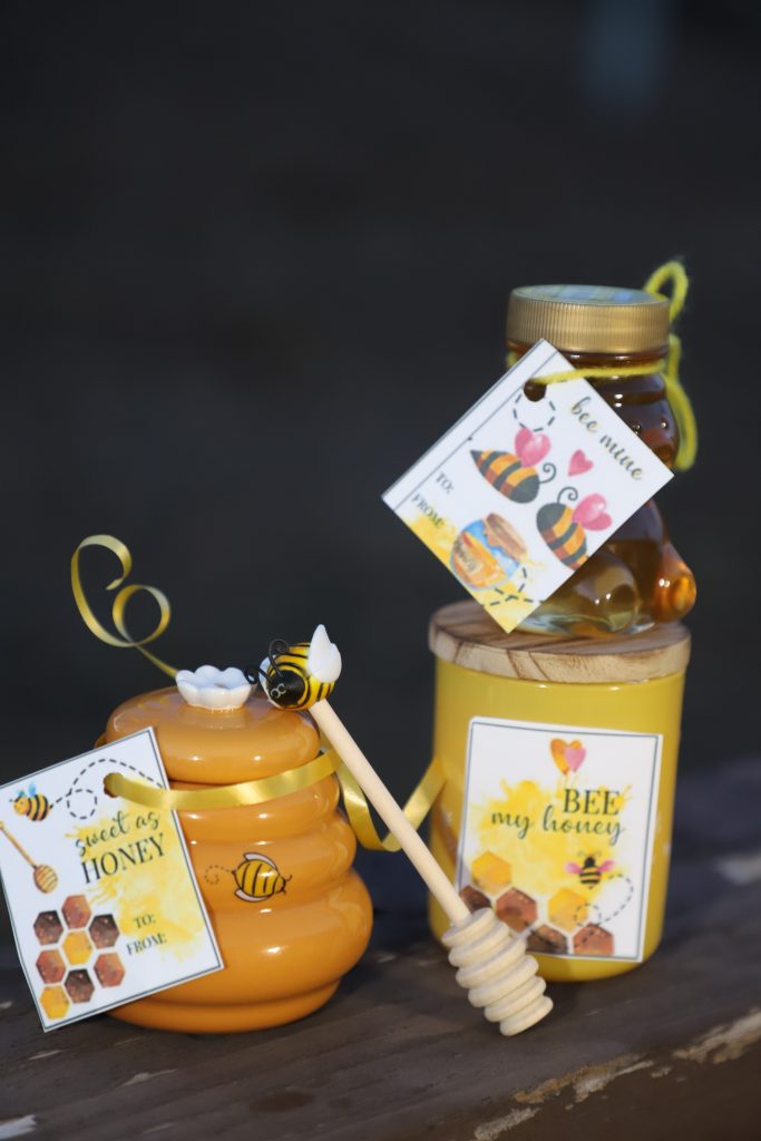 Honey jar with bee-themed labels and accessories, perfect for gift giving or honey lovers. Featuring adorable bee decorations and personalized tags for a sweet touch.