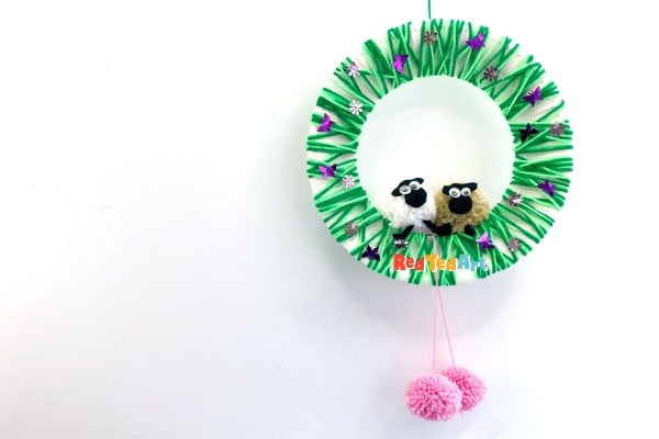 Colorful St. Patrick's Day wreath featuring cute sheep plush dolls, green fringe, and festive accents, perfect for celebrating holidays and adding charm to home decor.