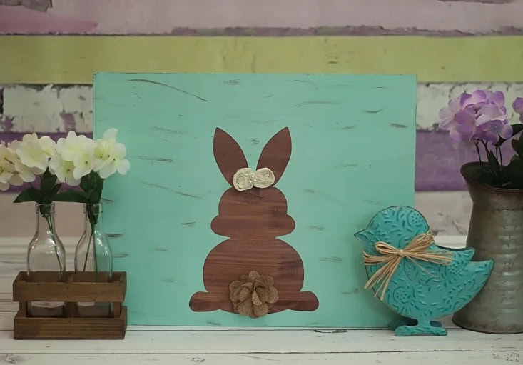 Colorful bunny wall art with fabric flower and accessories, perfect for spring or Easter decoration. Bright, cheerful, and handmade for festive occasions.