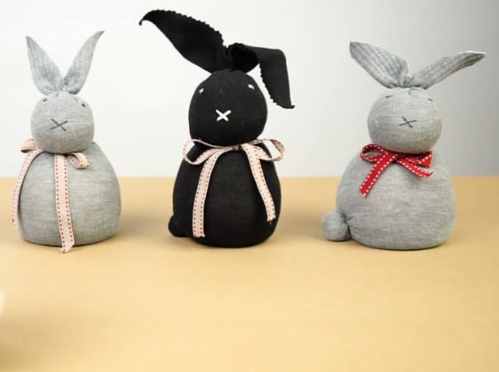 Adorable handmade bunny plushies in gray and black with charming ribbons, perfect for gifting or home decor from A Hundred Affections.