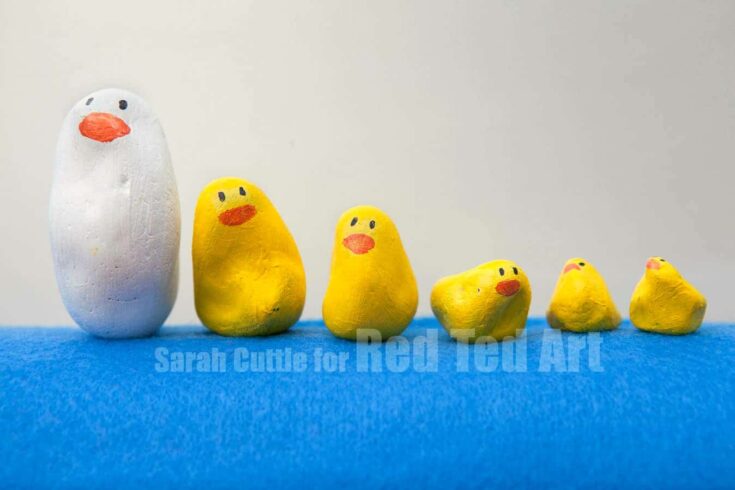 Colorful handmade chick figures for home decor and gifts, featuring bright yellow and white painted designs on textured surfaces, perfect for Easter or spring celebrations.