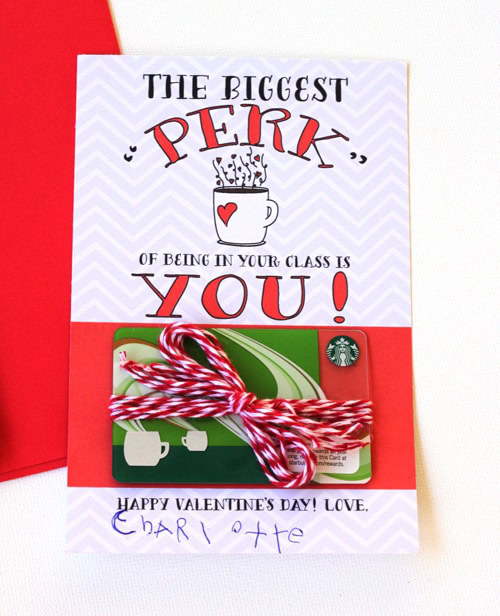 A heartfelt Valentine’s Day card reading "The biggest perk of being in your class is you!", featuring a Starbucks gift card with a red and white striped ribbon, perfect for expressing love and appreciation.