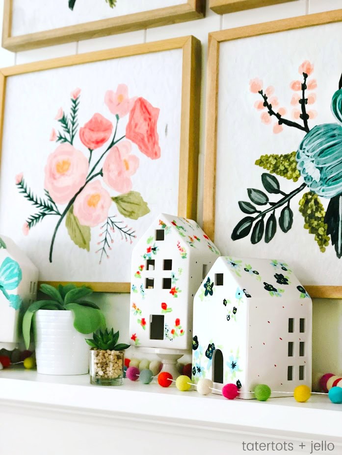 Bright floral artwork with charming painted houses and plant accents, perfect for cozy, colorful home decor from A Hundred Affections.