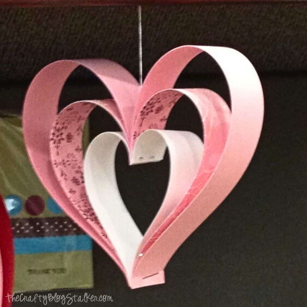 Colorful paper hearts wall decor for love-themed celebrations and home decoration.