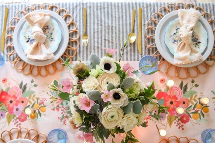 Beautiful floral table arrangement with roses, anemones, and greenery for brunch or special occasions.