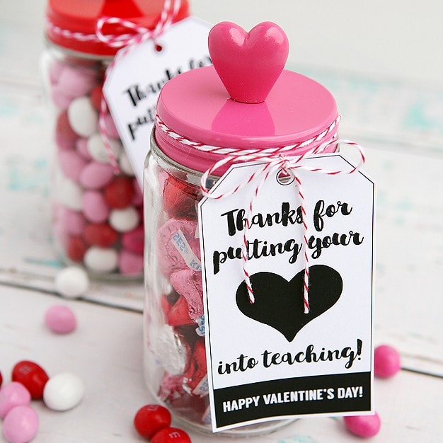 Colorful Valentine's candy jar with pink lid and heart adornment, perfect for expressing love and gratitude, ideal for Valentine's Day gifts or teacher appreciation.