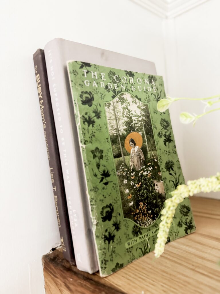 A Hundred Affections - The Corona Garden Guide book on gardening and plant care, featuring a green cover with botanical illustrations and a central image of a person in a garden setting.