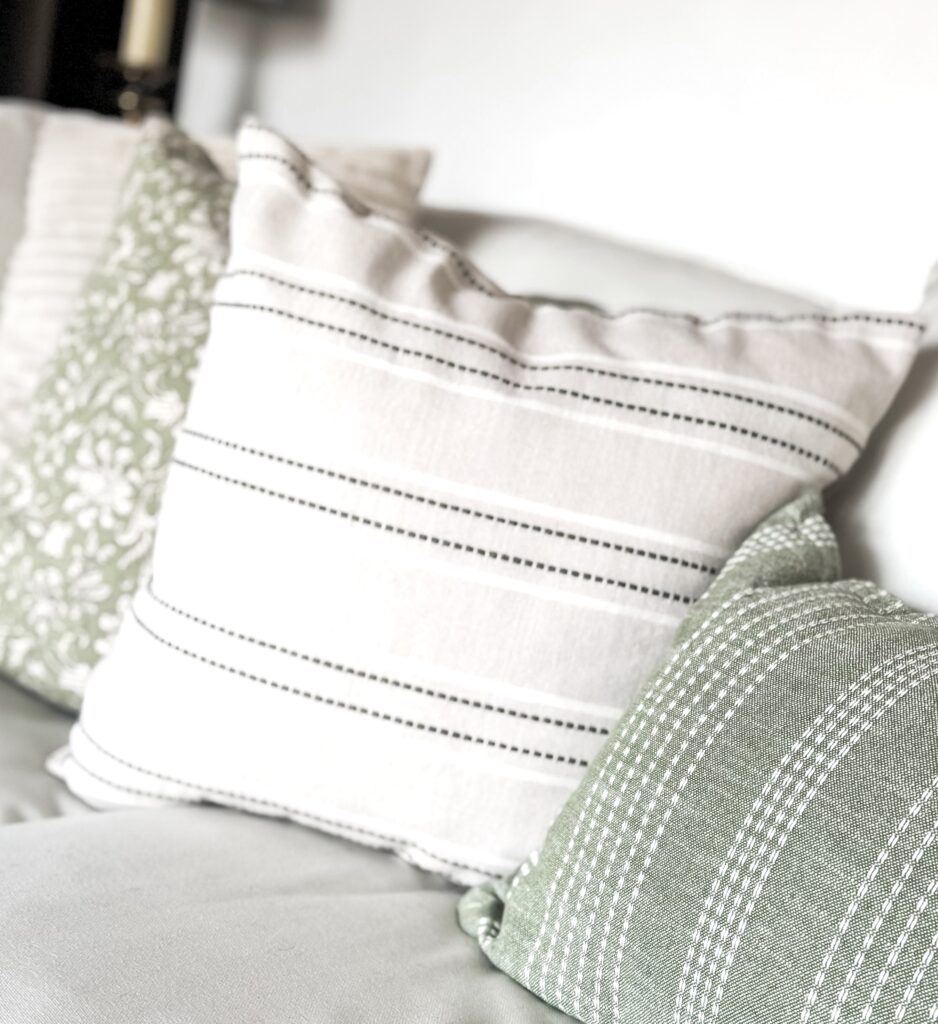Elegant linen throw pillows with striped patterns, perfect for enhancing living room or bedroom aesthetics, showcasing quality craftsmanship and timeless style.