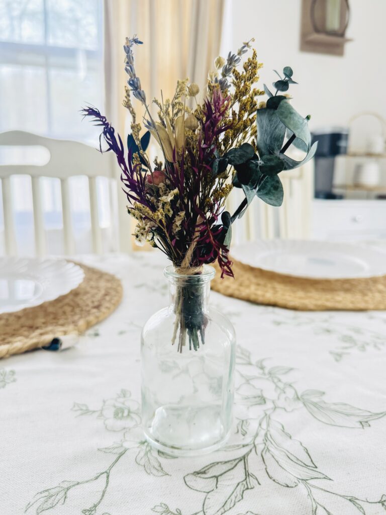 Beautiful dried flower bouquet in a clear glass vase, perfect for rustic or vintage home decor, featuring lavender, eucalyptus, and other dried botanicals.