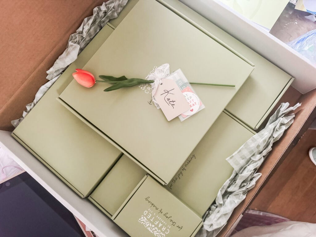 Elegant gift box set from A Hundred Affections, featuring beautifully packaged items with a single pink tulip, perfect for special occasions and heartfelt gifts.