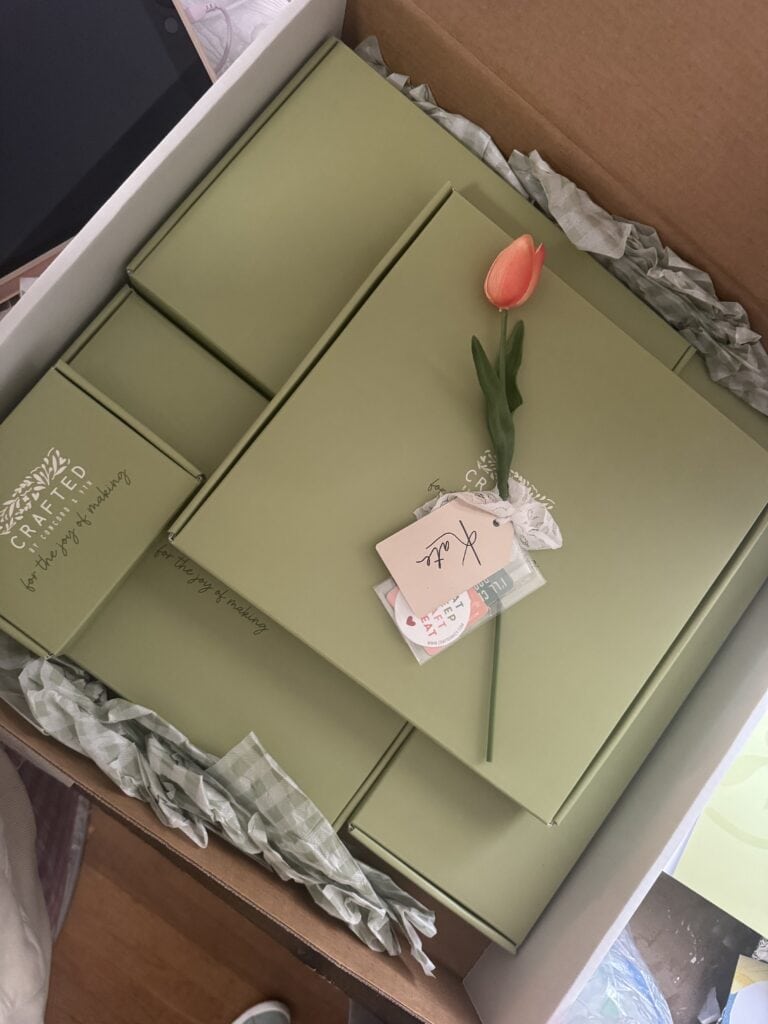 Elegant gift box with a pink tulip and personalized note for special occasions.