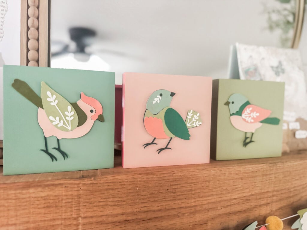 Colorful paper bird wall art for nursery or home decor.