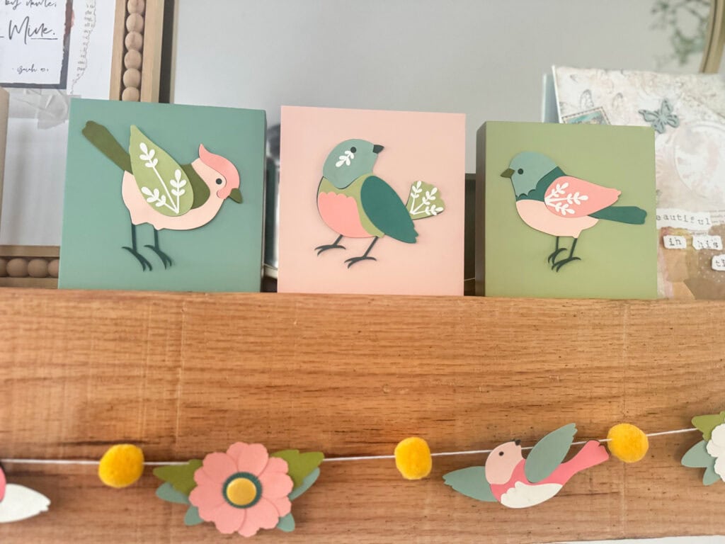 Bright and charming bird-themed wall decor featuring pastel-colored canvases with playful bird illustrations, perfect for nursery or children's room decor.