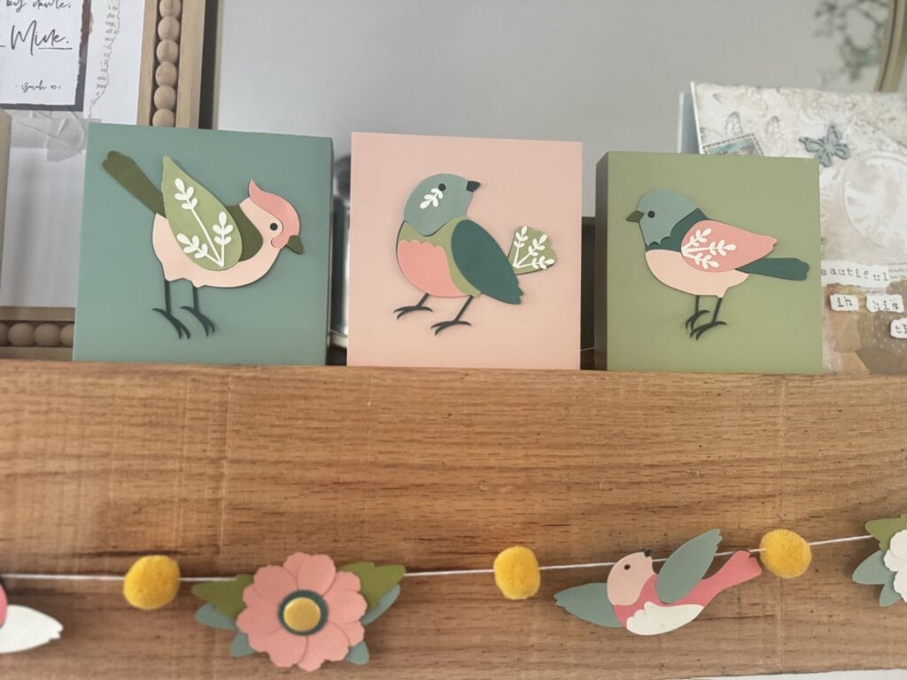 Colorful handcrafted bird wall art set featuring three charming bird illustrations on pastel backgrounds, perfect for nursery decor, children's room, or spring-themed home decoration.