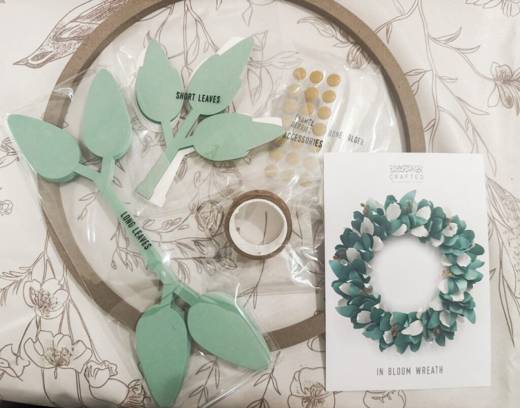 Bright green leaf-shaped paper craft kit for DIY bloom wreath, includes adhesive dots and instructions, perfect for home decor and creative projects.
