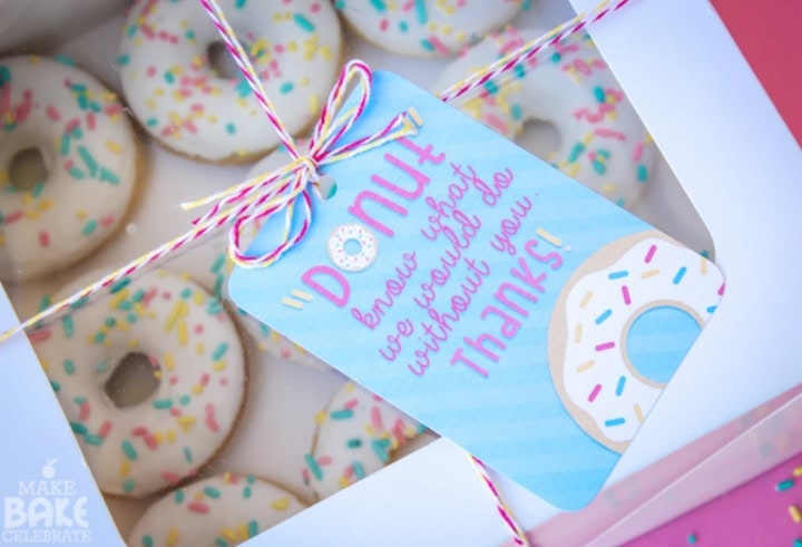Delicious assorted donuts with colorful sprinkles in a gift box, perfect for celebrating special occasions and expressing gratitude.