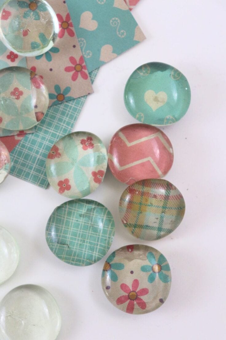 Colorful, patterned buttons with floral, plaid, and heart designs, perfect for holiday crafts and DIY Christmas gift projects.