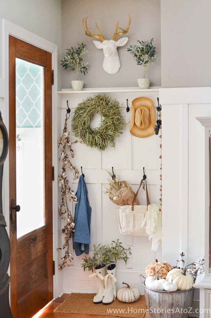 Charming fall home decorating ideas featuring a wreath, pumpkins, and rustic accents for a cozy autumn ambiance.