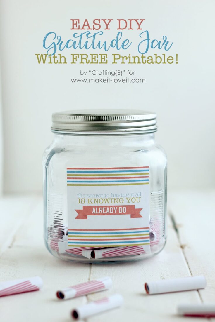 A clear glass jar with a colorful gratitude note inside, surrounded by rolled paper notes, promoting easy DIY gratitude jars with free printable for positive mindset.