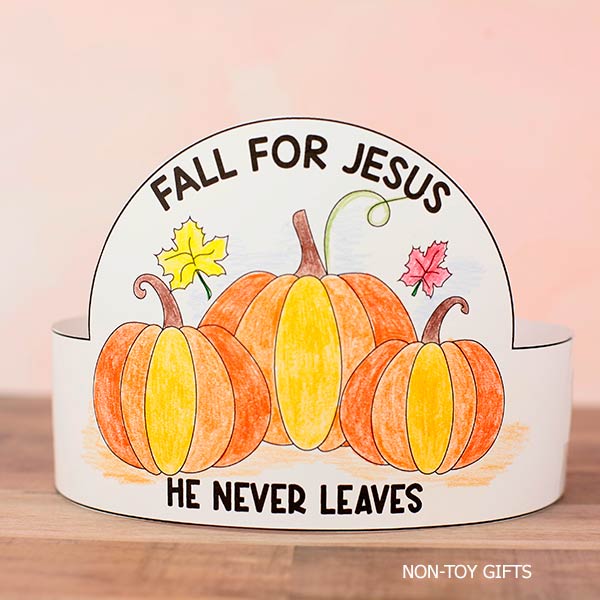 Decorative fall-themed sign with pumpkins and leaves, featuring the message 'Fall for Jesus, He Never Leaves' for seasonal religious home decor.