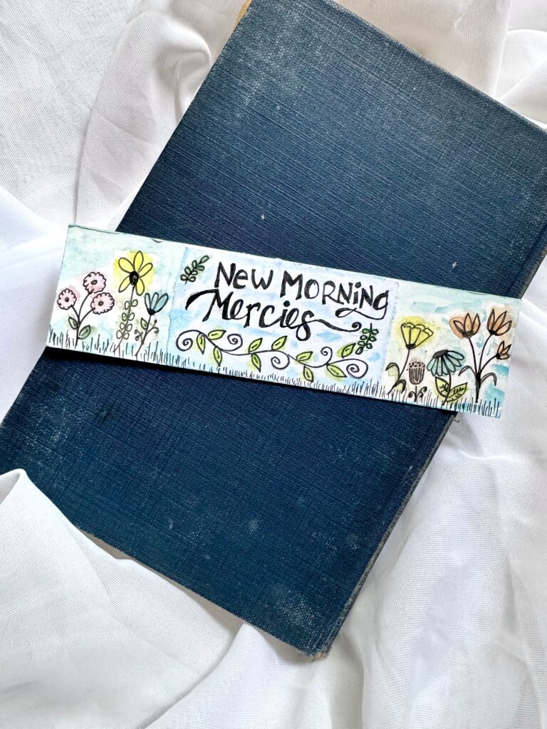 Colorful handmade bookmark with flowers and the message 'New Morning Mercies' for daily inspiration, perfect for Bible or journal reading.