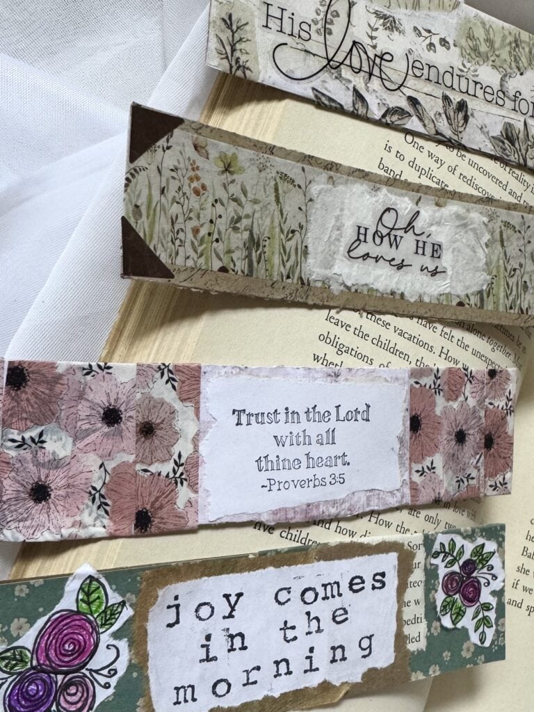 Set of handmade paper bookmarks with inspirational quotes and floral designs, perfect for gift-giving or personal use, showcasing craft and creativity.