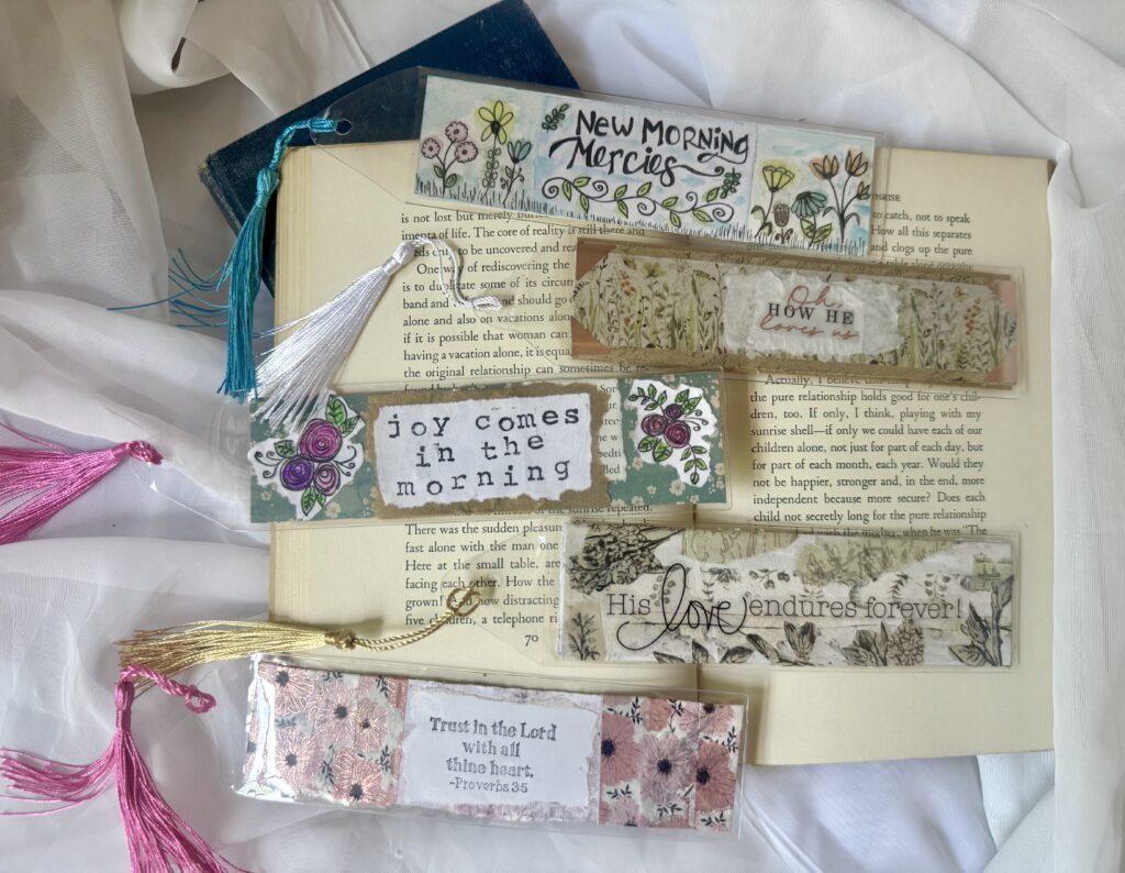 Collection of handmade bookmarks with floral designs, inspirational quotes, and decorative tassels, perfect for journaling and gift-giving.