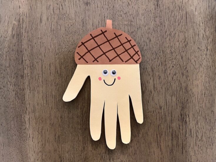 Adorable handmade octopus wall hanging with a smiling face, pink cheeks, and a brown checkered hat, perfect for children's room decor or playful home accents.