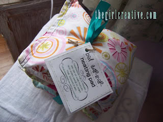 A beautifully wrapped DIY bath and body gift set with colorful wrapping paper, a ribbon, and a tag, perfect for homemade Christmas gifts for family.