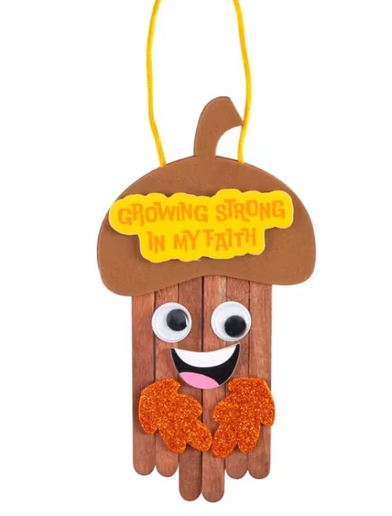 Cute door hanger with a smiling face, googly eyes, orange glittery hands, and a yellow sign that says 'Growing Strong in My Faith' for children's faith-based decor.