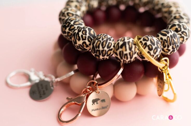 Stacked beaded bracelets featuring leopard print, maroon, and blush beads with gold and silver charms, perfect for DIY jewelry projects or gift ideas.