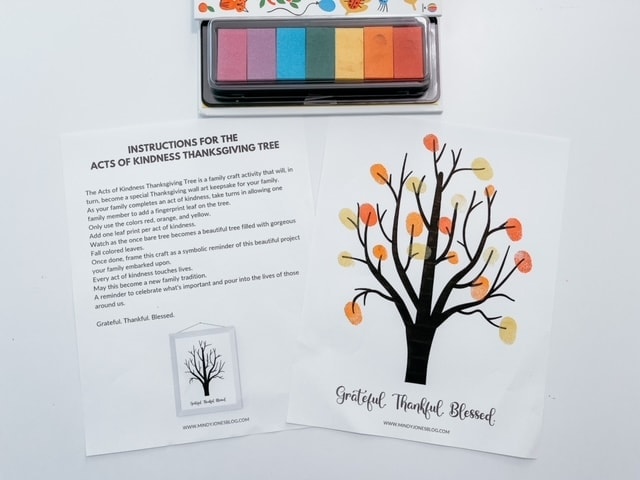 Thanksgiving themed craft with a black paper tree and colorful paper leaves, accompanied by instructions for creating a gratitude tree for Thanksgiving celebrations.