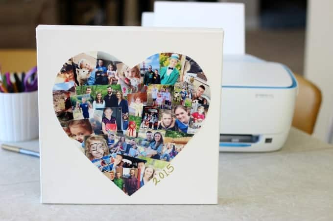 Custom photo collage in a heart shape on a white canvas, featuring family and friends, with the year 2015, displayed on a desk with a printer in the background.