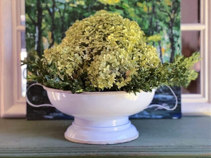 Beautiful green hydrangea floral centerpiece in a white pedestal bowl, perfect for fall home decor and seasonal decorating ideas.