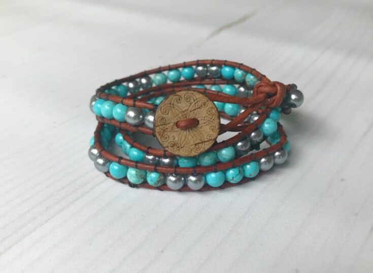 Handcrafted wrap bracelet featuring turquoise and gray beads with a decorative button closure, perfect for boho or casual style accessories.