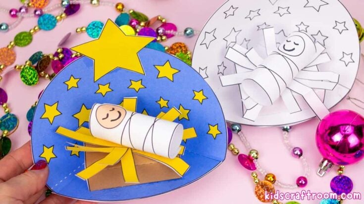 Colorful handmade paper nativity scene craft with stars, angel, and baby Jesus, perfect for Christmas decorations and educational activities.