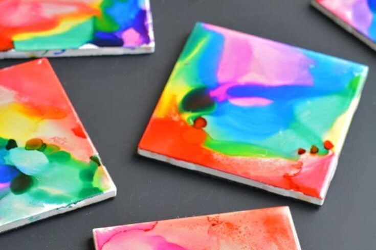 Abstract watercolor paintings with vibrant colors and fluid shapes, displayed on a dark surface, showcasing artistic creativity and modern design.
