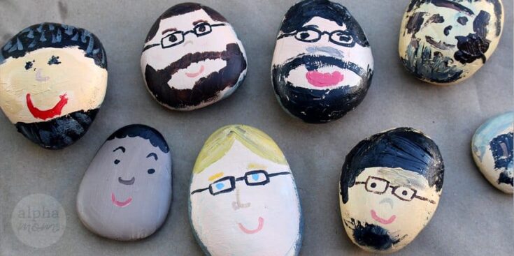 Colorful painted rocks with smiling faces and glasses, arranged on a surface, representing creative and artistic rock art for home decor or garden embellishments.