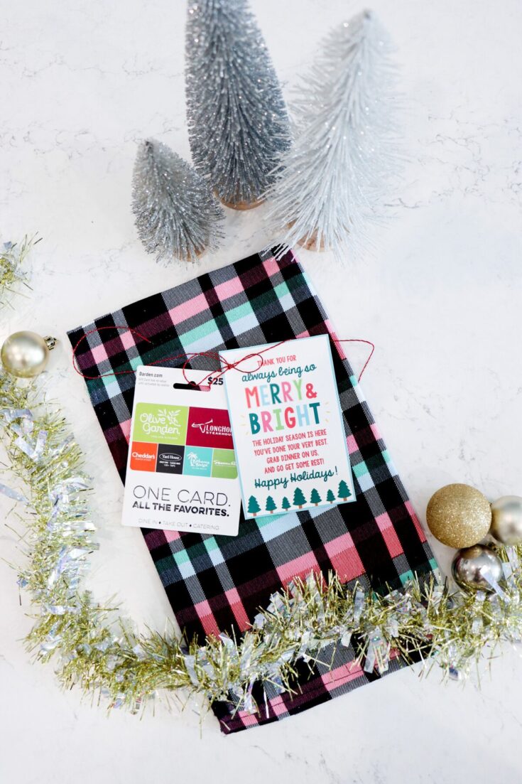 Festive holiday gift card holder with Christmas ornaments, tinsel, and mini Christmas trees on a white background, perfect for holiday gift giving.