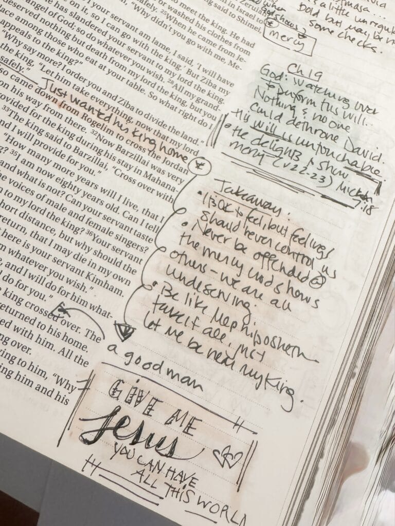 Close-up of handwritten Bible notes and prayer on paper, including verses, reflections, and a prayer for Jesus, with a focus on faith and spirituality.